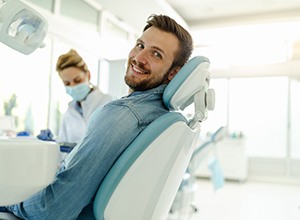 Man smiling while sitting in treatment chair