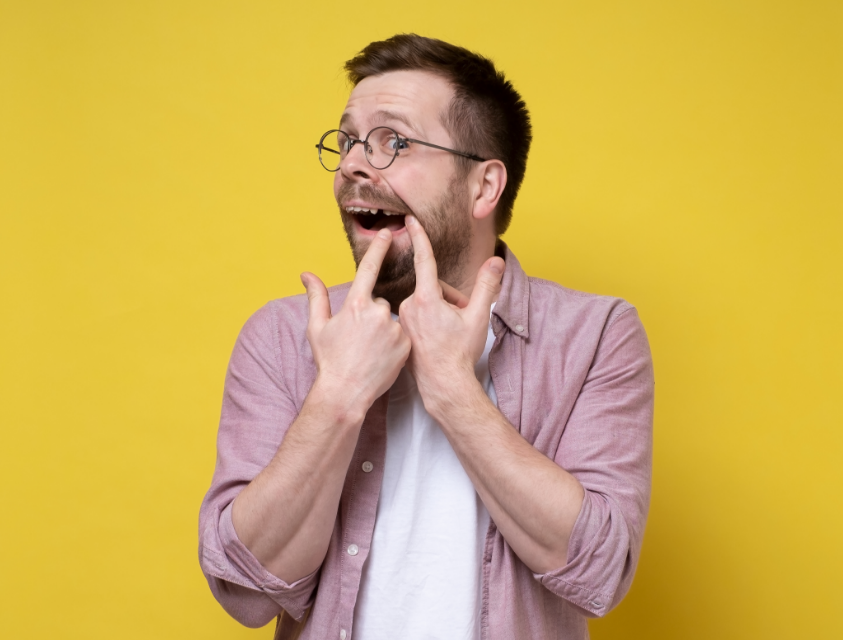Man pointing at missing tooth